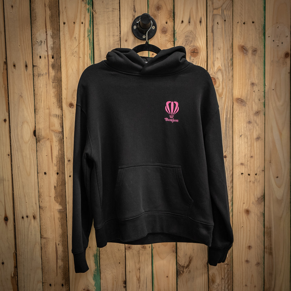 Boujon Bakery men's relaxed fit hoodie in black, front with pink logo